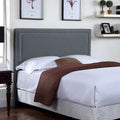 Tête de lit capitonnée en tissu avec bordure cloutée